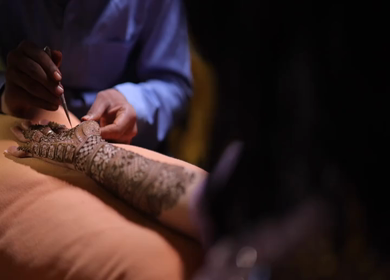 A Slow Motion Shot of Applying Mehndi on Bride's hand at her Indian Wedding in India