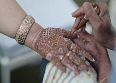 A Slow Motion Shot of Applying Mehndi on Bride's hand at her Indian Wedding in India