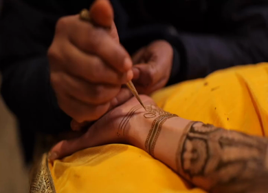 A Slow Motion Shot of Applying Mehndi on Bride's hand at her Indian Wedding in India