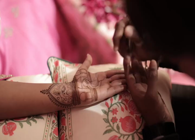 A Slow Motion Shot of Applying Mehndi on Bride's hand at her Indian Wedding in India