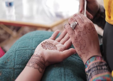 A Slow Motion Shot of Applying Mehndi on Bride's hand at her Indian Wedding in India