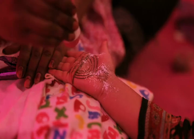 A Slow Motion Shot of Applying Mehndi on Bride's hand at her Indian Wedding in India