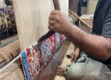 A Shot of a man working at a Silk Cloth Factory in Kashmir, India