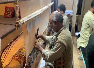 3rd October 2022: A Shot of two men working at a Silk Cloth Factory in Kashmir, India