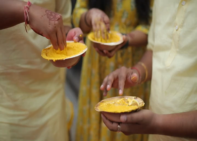 A Slow Motion Shot of People Mixing Haldi at an Indian Wedding in India