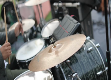 A shot of a musician playing drums instrument at an Indian Wedding function in India