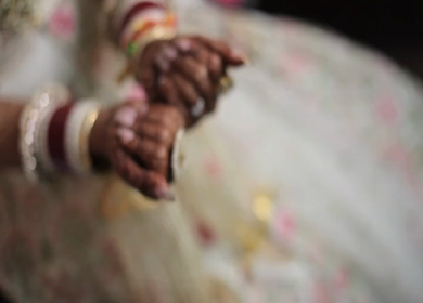 An Indian Bride showing Mehndi and chura in her Hands at her Indian Wedding 