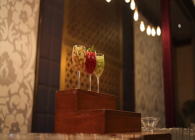 A slow motion shot of a bar with glasses of cocktails at an Indian wedding 