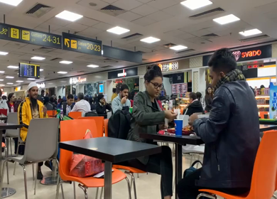 A shot of a people eating at food the New Delhi, Airport