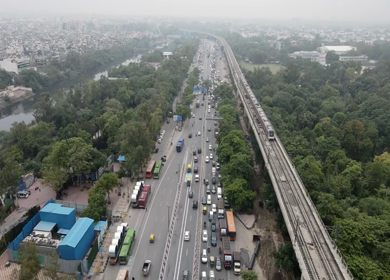 An aerial shot of Delhi Metro and road traffic at New Delhi India