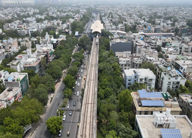 An aerial shot of the Delhi Metro moving in New Delhi, India