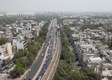 An aerial shot of the Delhi Metro moving in New Delhi, India