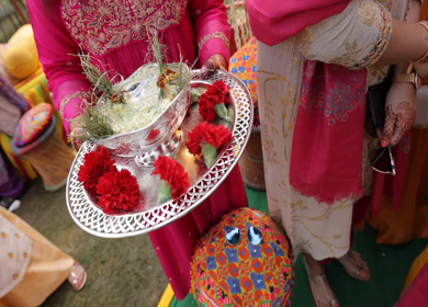 An Indian Girl carrying Puja Thali at an Indian Wedding in India