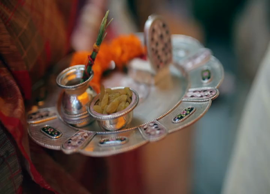 A shot of an Indian lady carrying a pooja thali at an Indian Wedding in New Delhi, India