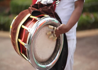 A shot of a musician playing the dholak instrument at a function in New Delhi, India