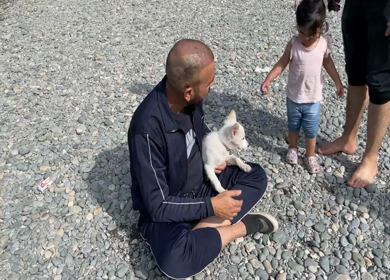 Kashmir, India - 3rd October 2022: A shot of a man playing with his dog at Betaab Valley at Pahalgam in Kasmir, India