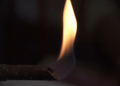 A static slow motion mid shot of a burner with flames coming out of it in India