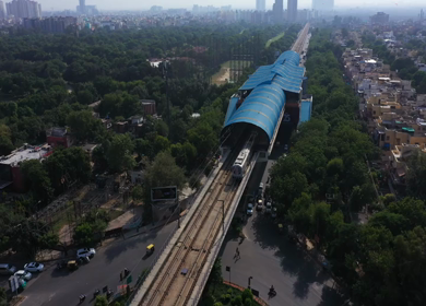 An aerial shot of the Delhi Metro leaving the station in New Delhi, India