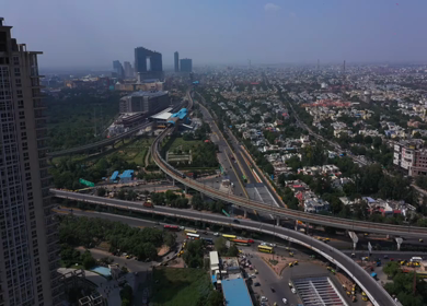 An aerial shot of the Delhi metro leaving the station in New Delhi, India