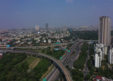 An aerial shot of the Delhi metro leaving the station in New Delhi, India