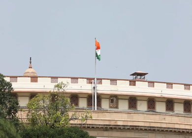A static shot of the Parliament House and Indias national flag in New Delhi, India