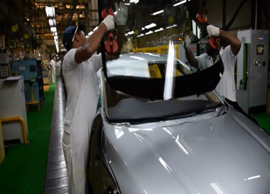 Greater Noida, CIRCA April 2017: windscreen being fixed in a car at car manufacturing plant in India
