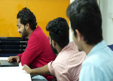 A shot of Indian colleagues having a casual conversation in their office conference room 