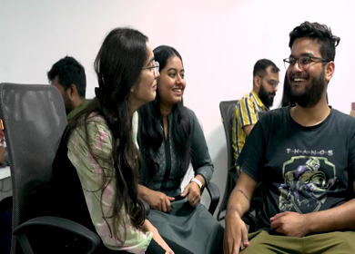 A shot of Indian colleagues having a casual conversation in their office conference room 