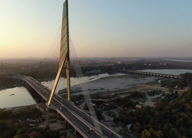 An aerial shot of the Signature Bridge with cars moving in New Delhi, India