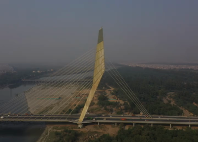 An aerial shot of the Signature Bridge with cars moving in New Delhi, India